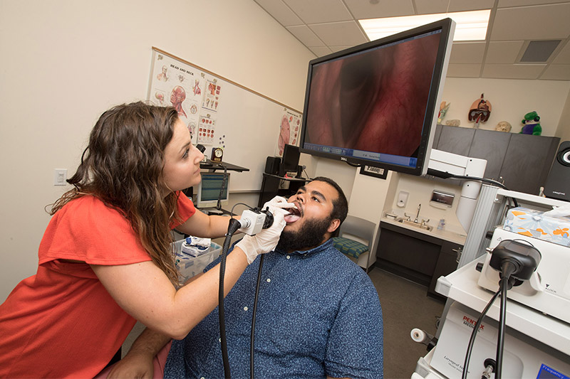 A Speech Pathology student works with a client