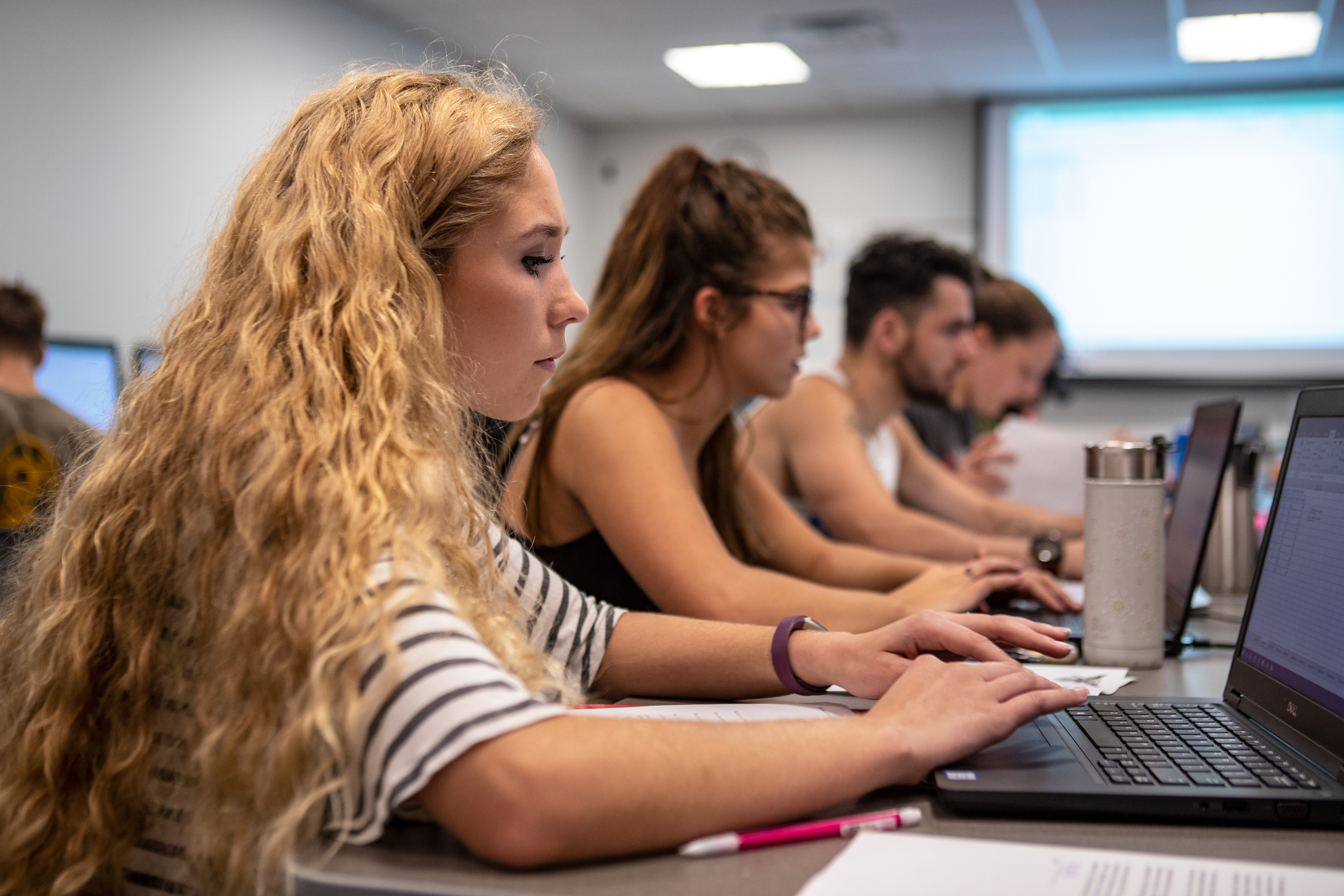Students focused on laptops in a Ball State classroom