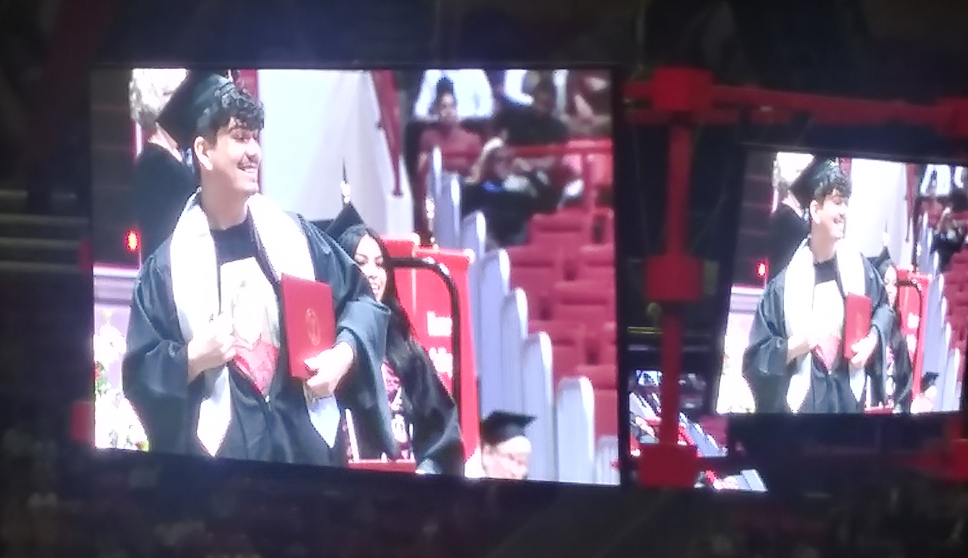 Student walks across commencement stage