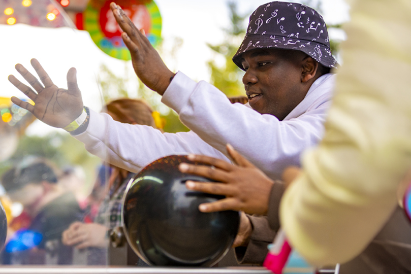 Student bowling at carnival