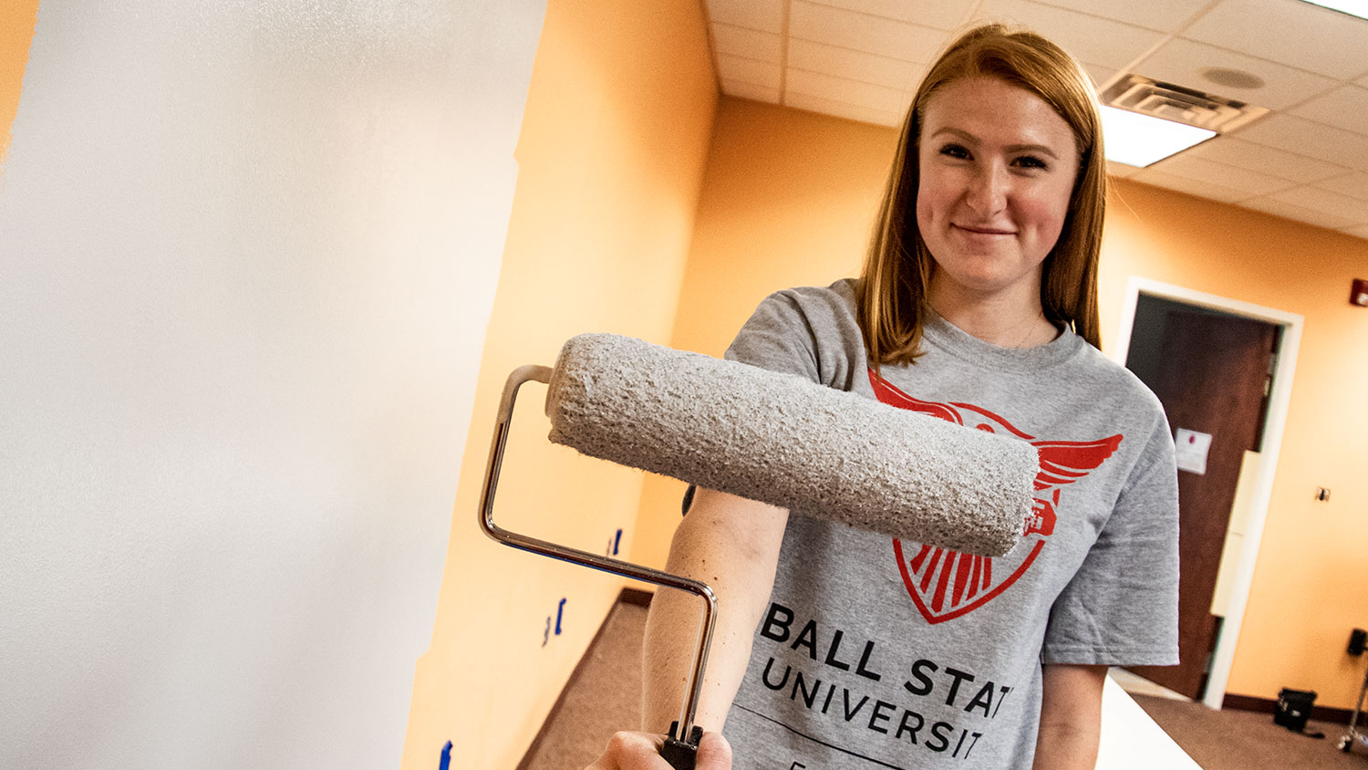 Student with paint roller