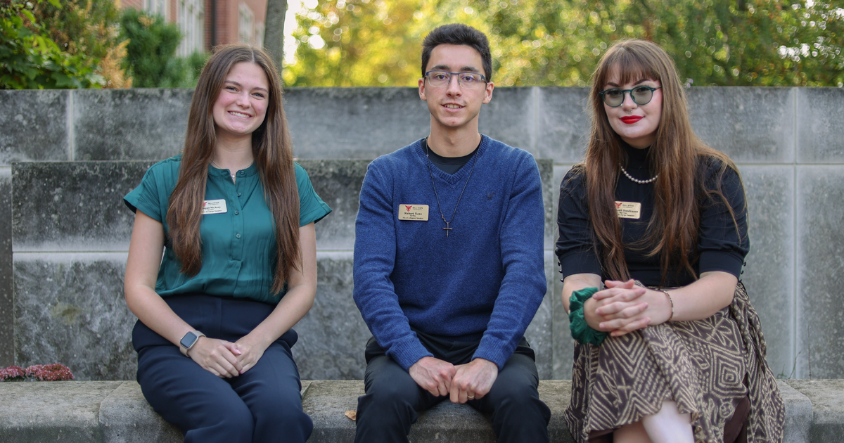 A collegiate senior and two senators at large captured in a photograph