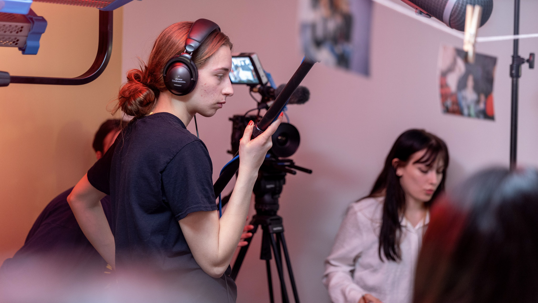 A student operates a boom mic on a Radiance Cinema film set