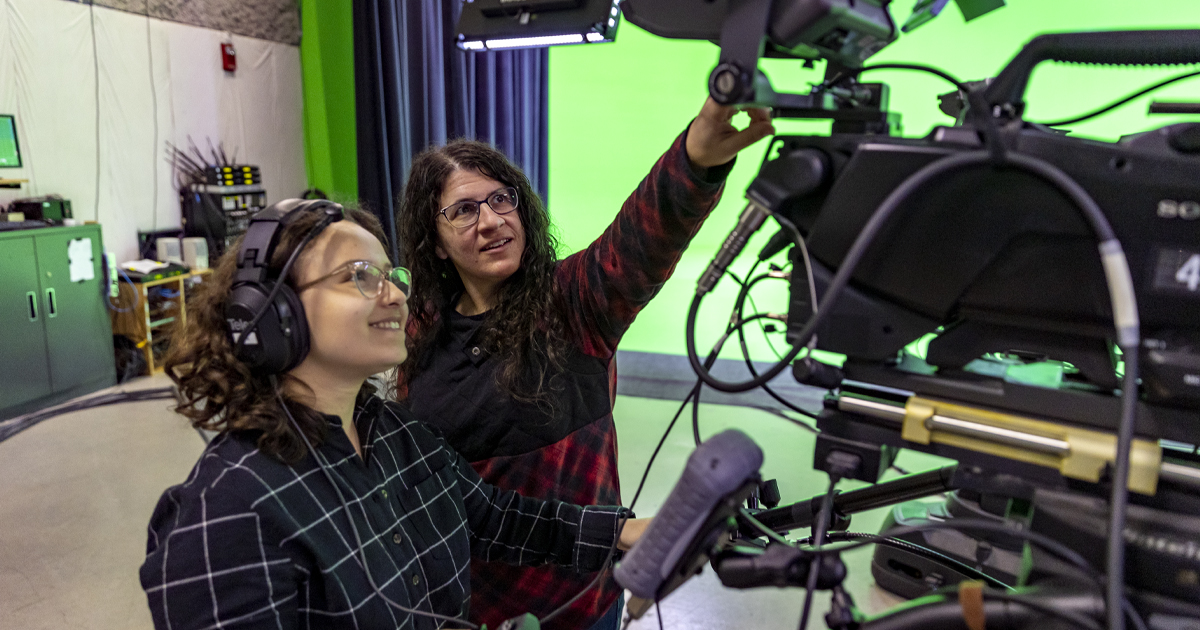 student and teacher controlling camera