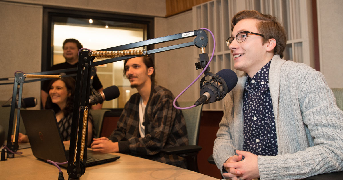 Students in the radio studio with microphones