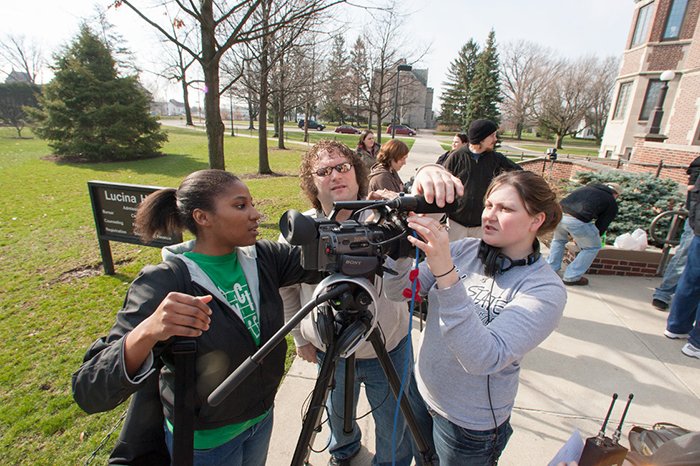 Students setting up a video camera near Lucina Hall. 