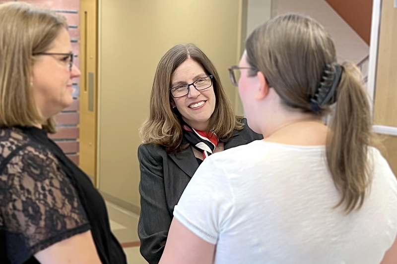 Dean Bulkley speaking with a student and parent.