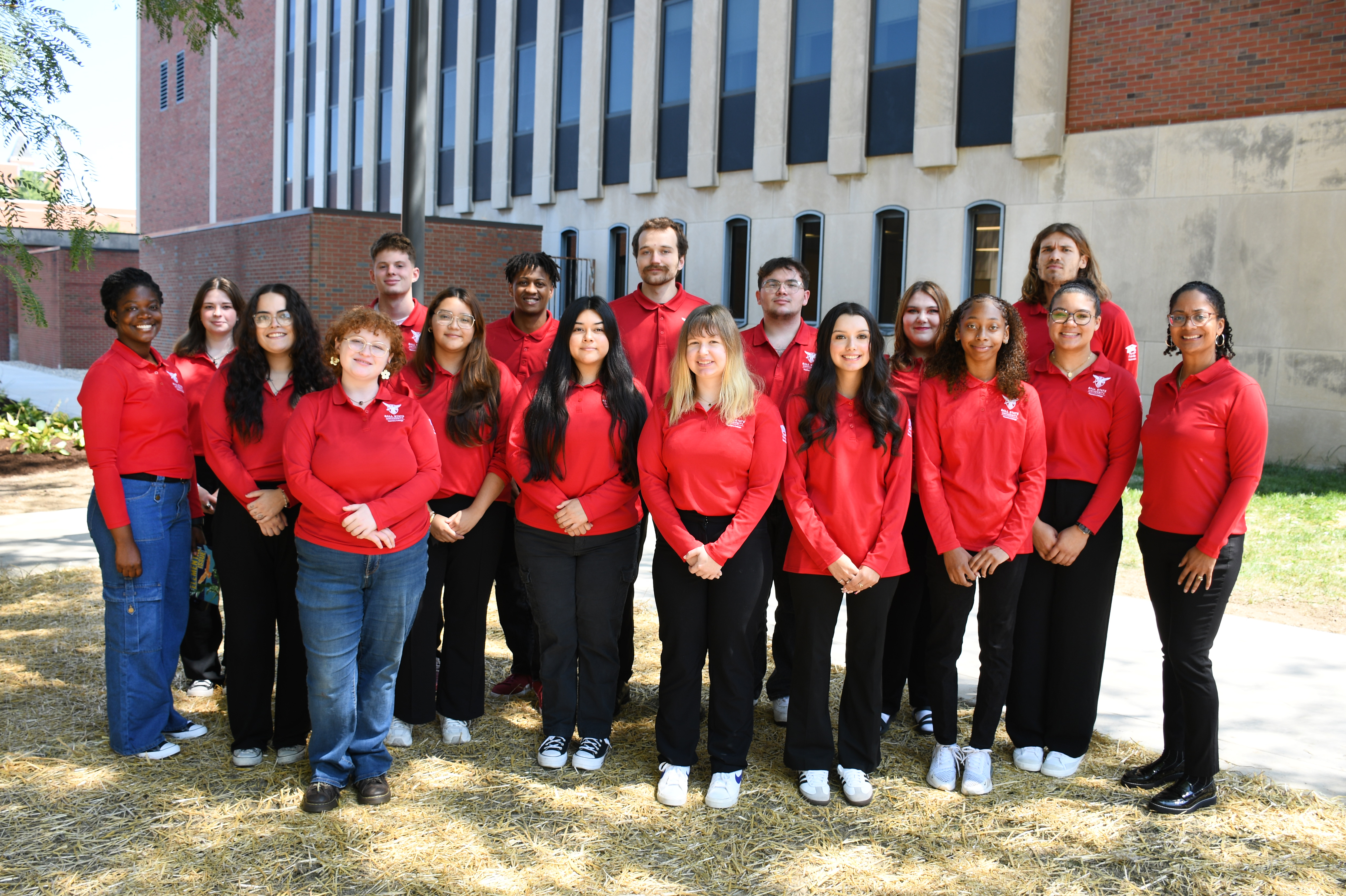 Group of students, and staff stand in front of the Teachers College building on the Ball State University campus.