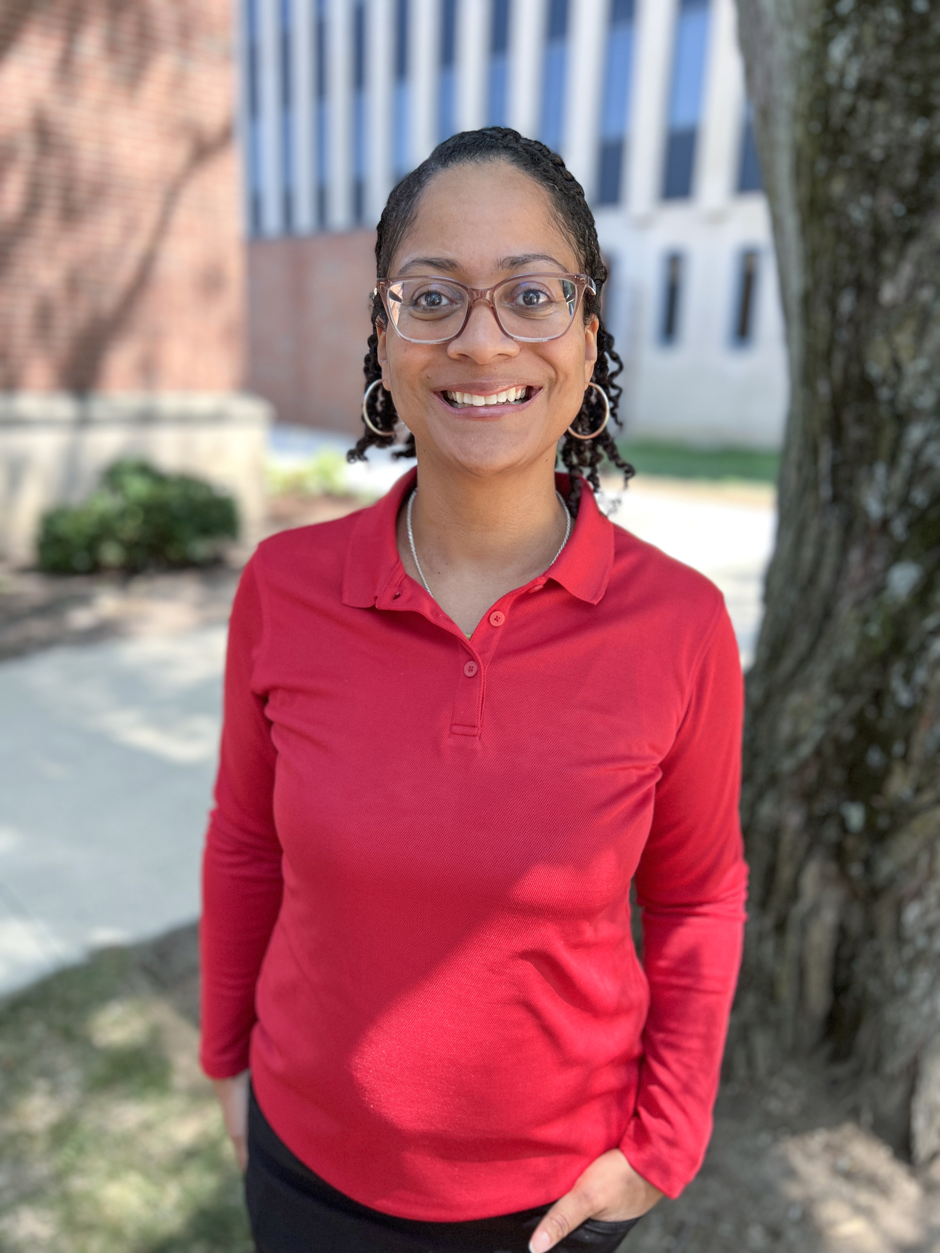 Headshot of a woman standing in front of the Teachers College building on the Ball State University campus.