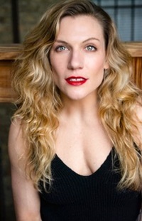 A white female with long blonde hair and wearing a black tank top.