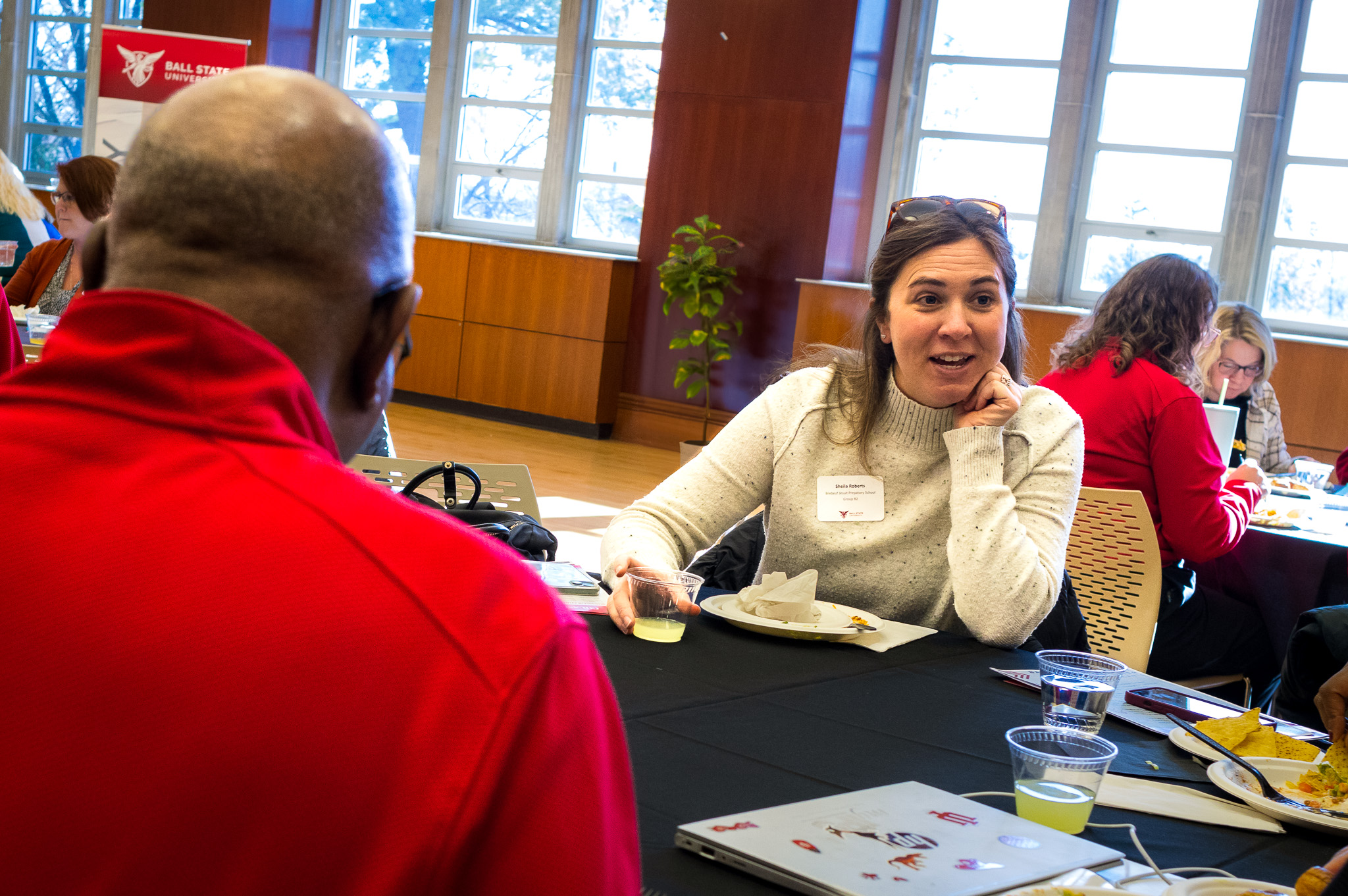 A high school counselor engages in discussion with Ball State Admissions staff during lunch at Counselor Connection Day.