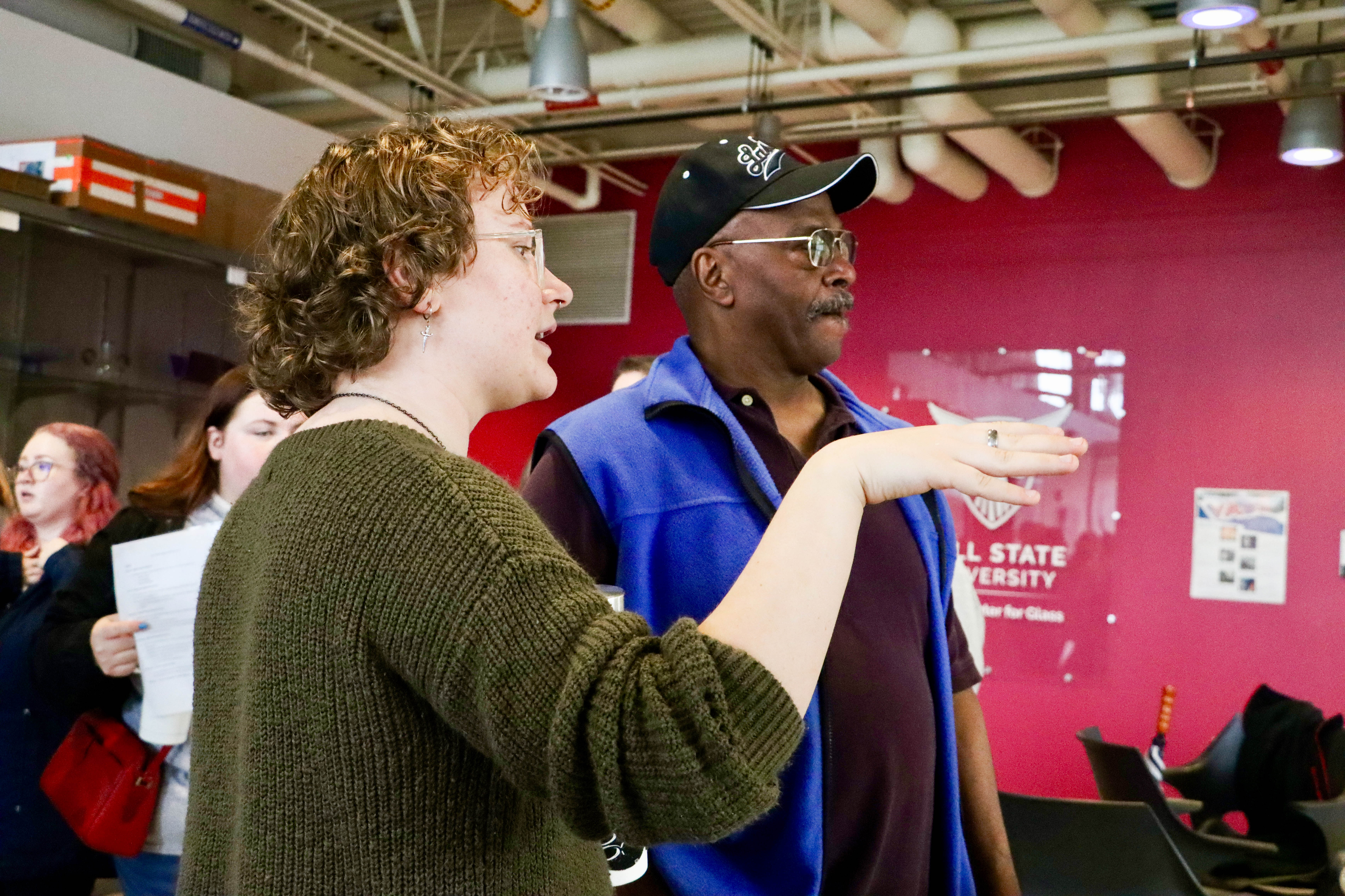 Woman discusses Ball State's Glick Center for Glass to a high school counselor visiting campus for Counselor Connection Day.