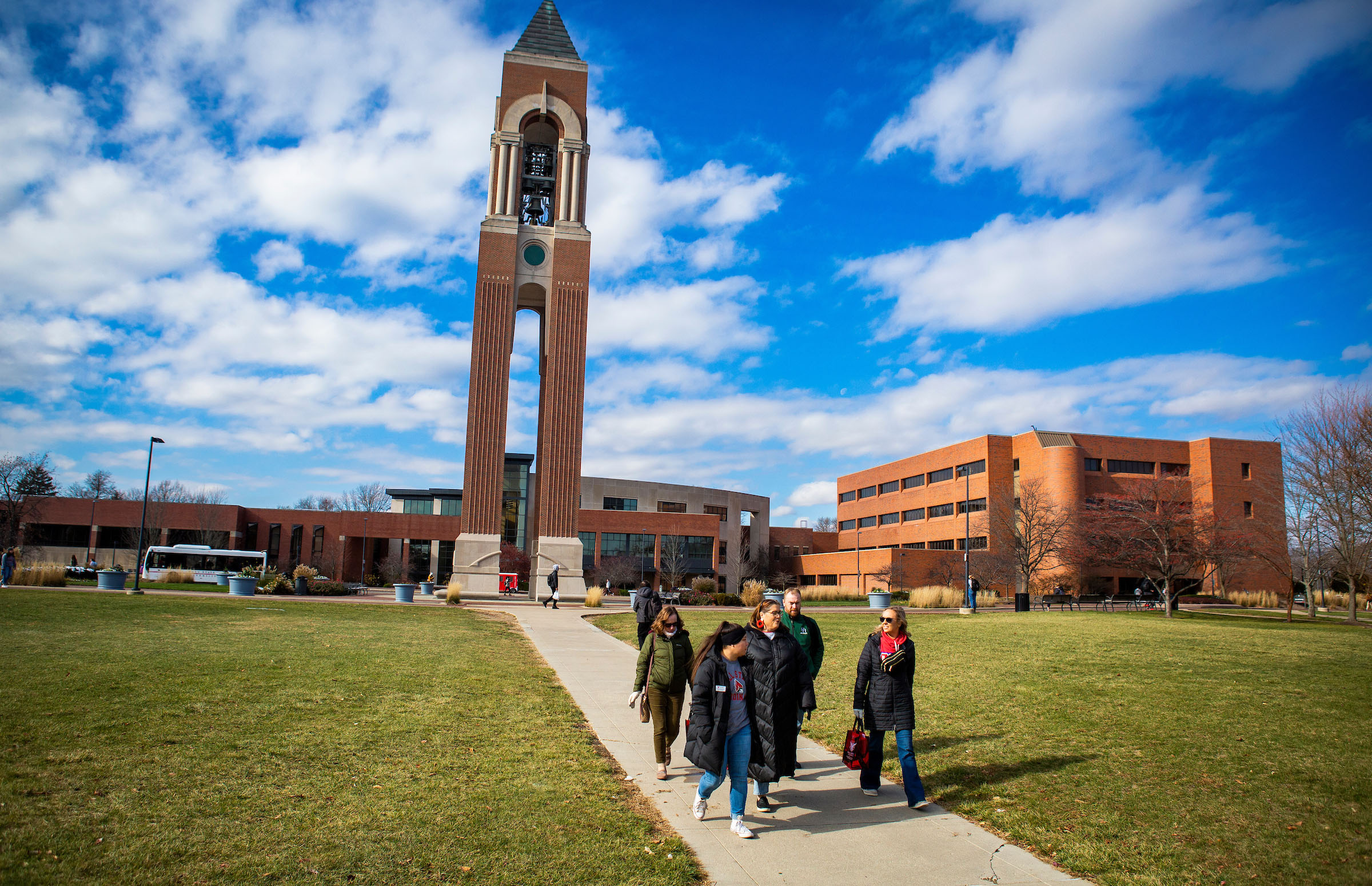 A group of counselors walking around campus with Shafer Tower in the background