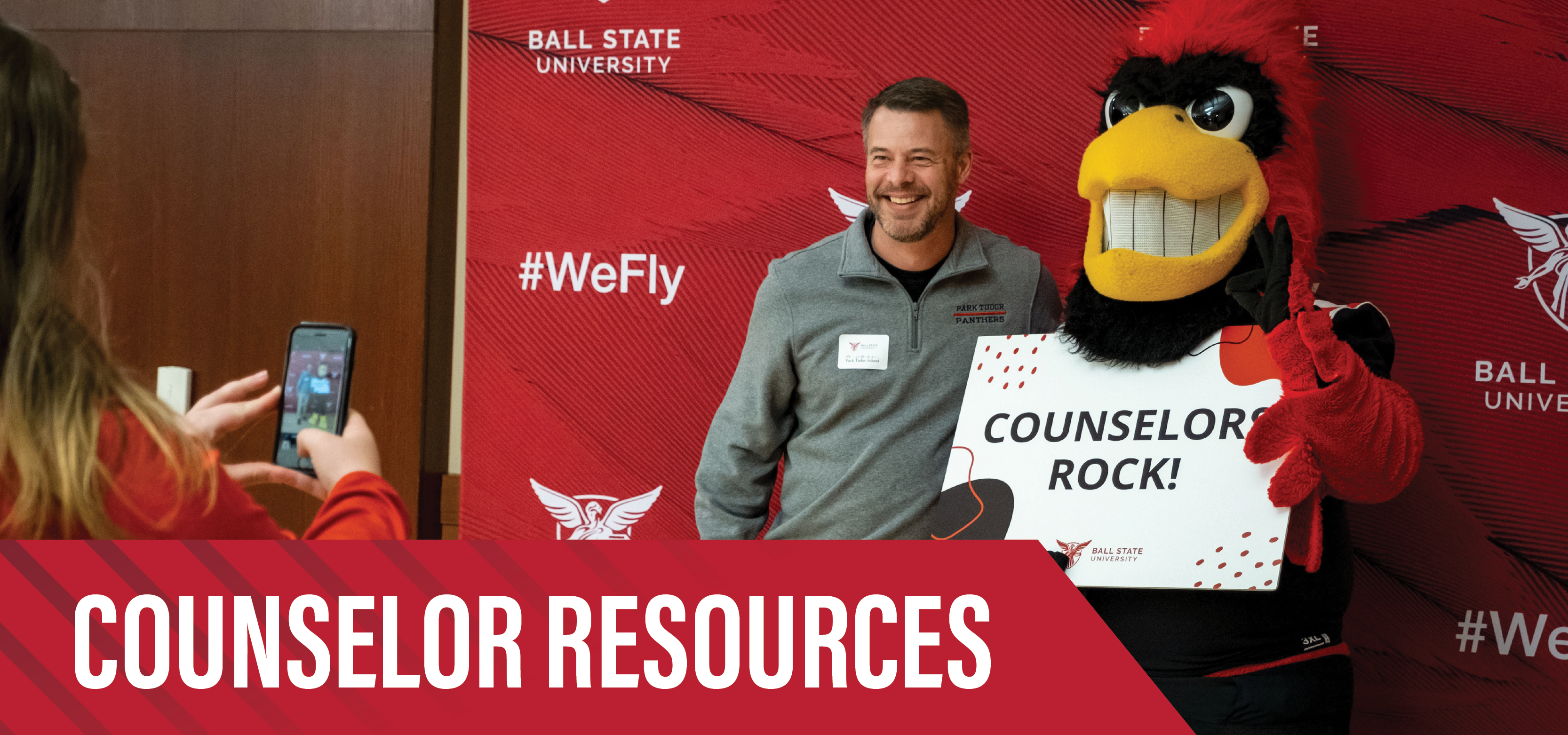 A high school counselor takes a photo with Charlie Cardinal during Counselor Connection Day at Ball State University with text, Counselor Resources.