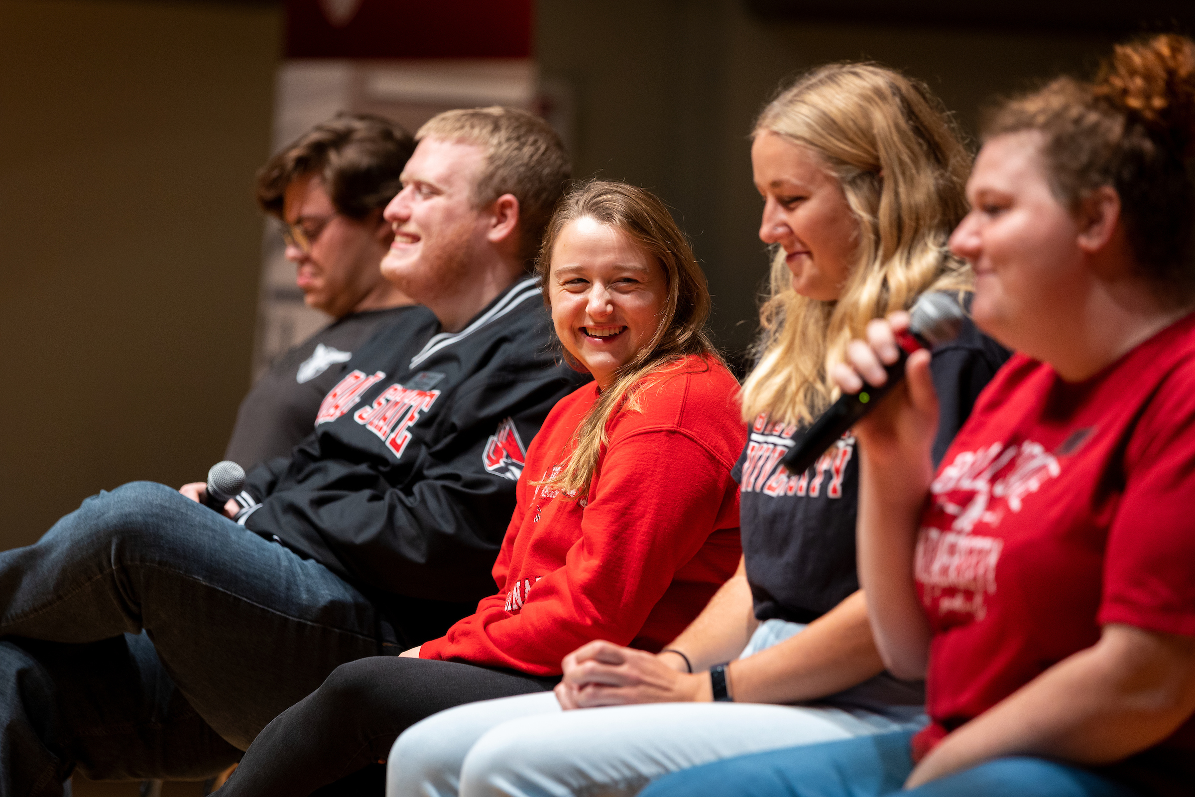 A group of current students sitting on the Pruis Hall stage answering questions from the audience