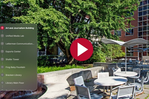 Tour screenshot of the art and journalism building, menu on the left with a play button in the center and a building in the background