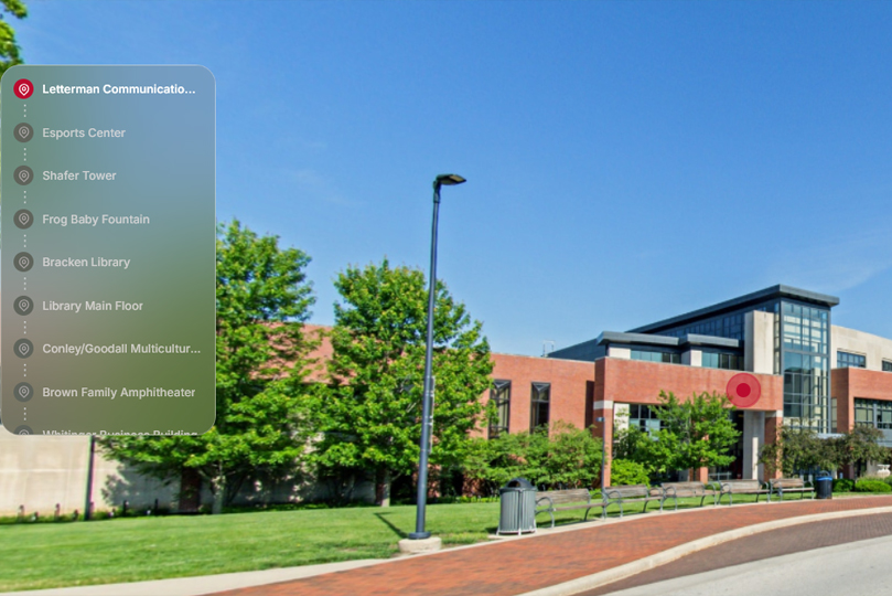 Campus Reel screenshot-on the left a list of buildings with the David Letterman building on the right, sidewalk with brick building in the background