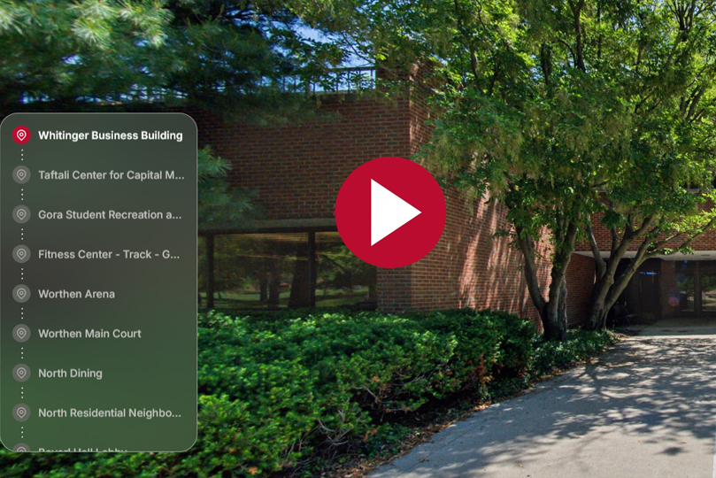 tour screenshot of the whitinger business building, a menu on the left, a play button in the center and a brick building surrounded by trees in the background