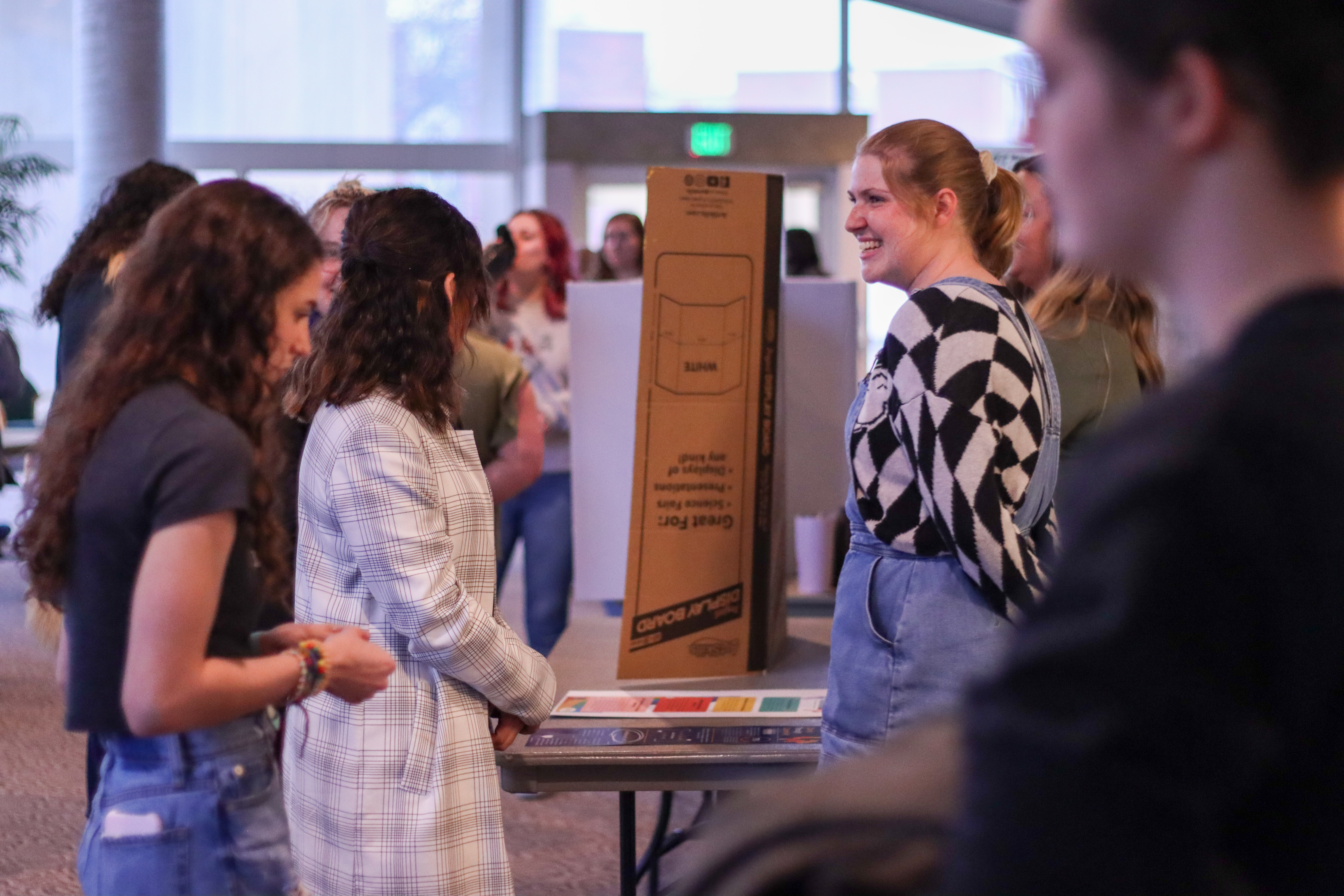 Women's and Gender Studies student presenting their posters from the capstone course in Pruis Hall