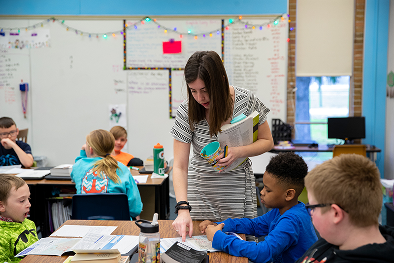 A teacher works with elementary school children