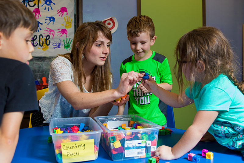 Student working with children
