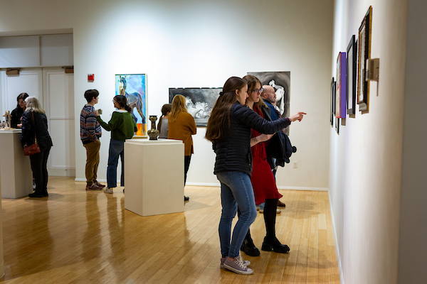 People viewing art in the Ned and Gloria Griner Gallery