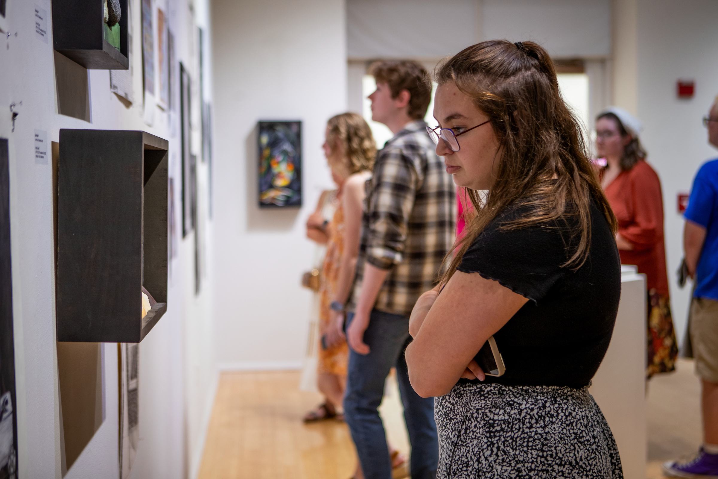 People viewing art in the Ned and Gloria Griner Art Gallery
