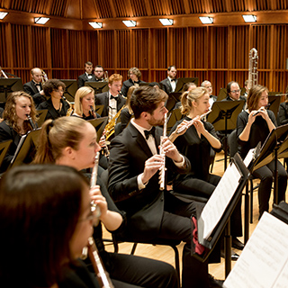 Members of a concert band performing on stage