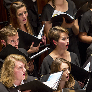 Choir members performing on stage