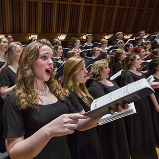 Choral musicians on stage performing