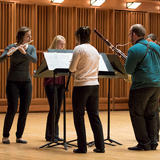A woodwind chamber group performing on stage