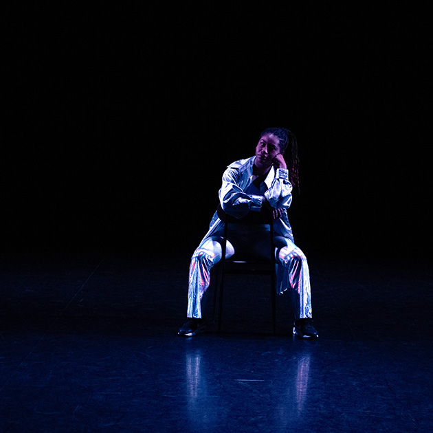 lone dancer sitting onstage during a performance