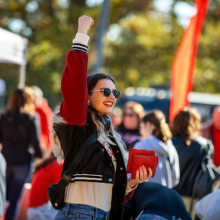 a girl cheering outside at Ball State University's CharlieTown