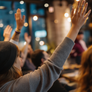 Girl raising her hand with group of people