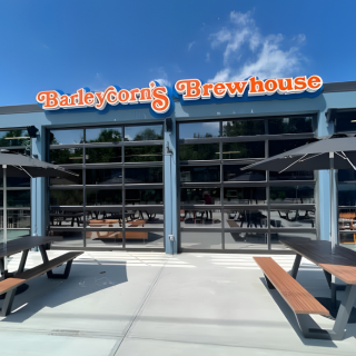 Outside of Barleycorn's Brewhouse with tables in front.