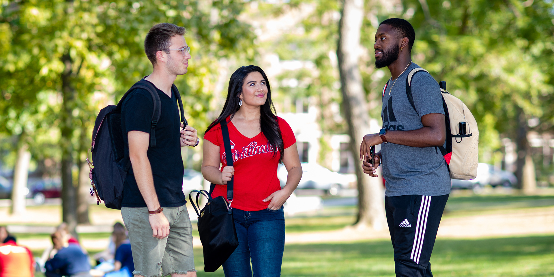 three students talking outside