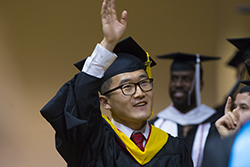 graduating student waving