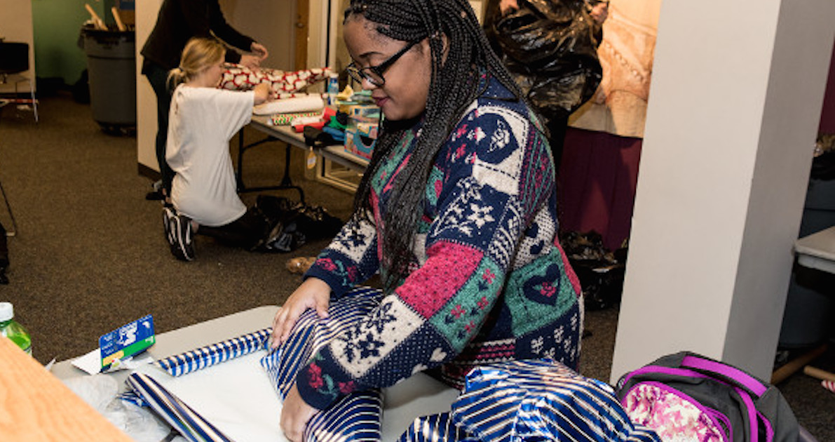 Student wrapping Angel Tree present
