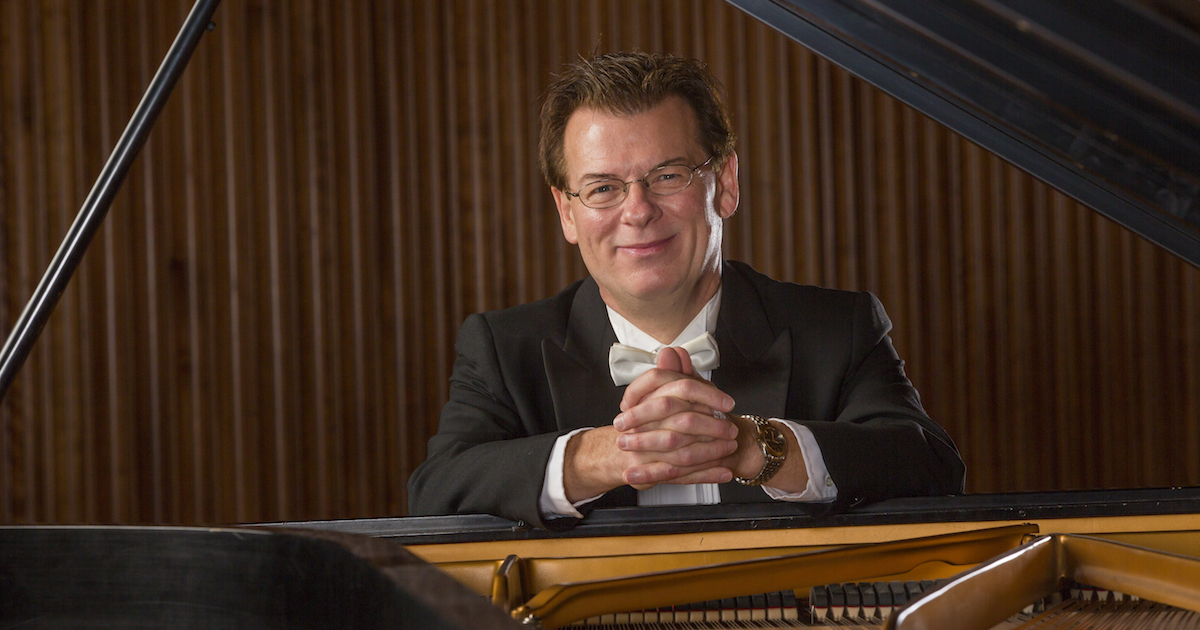 Robert Palmer sitting at a piano