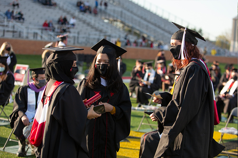 three graduates talking