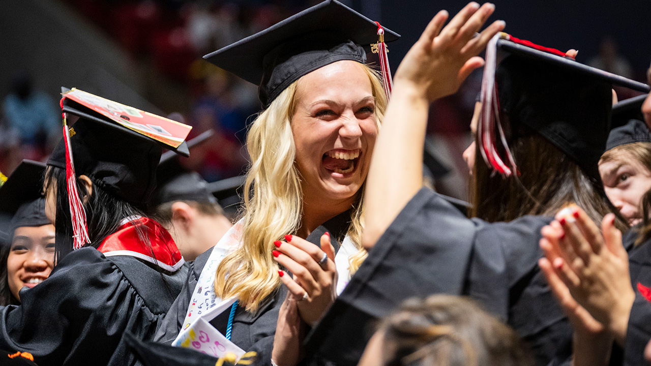 Student laughing and high five