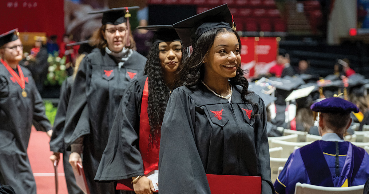 Students returning to seat after receiving diploma