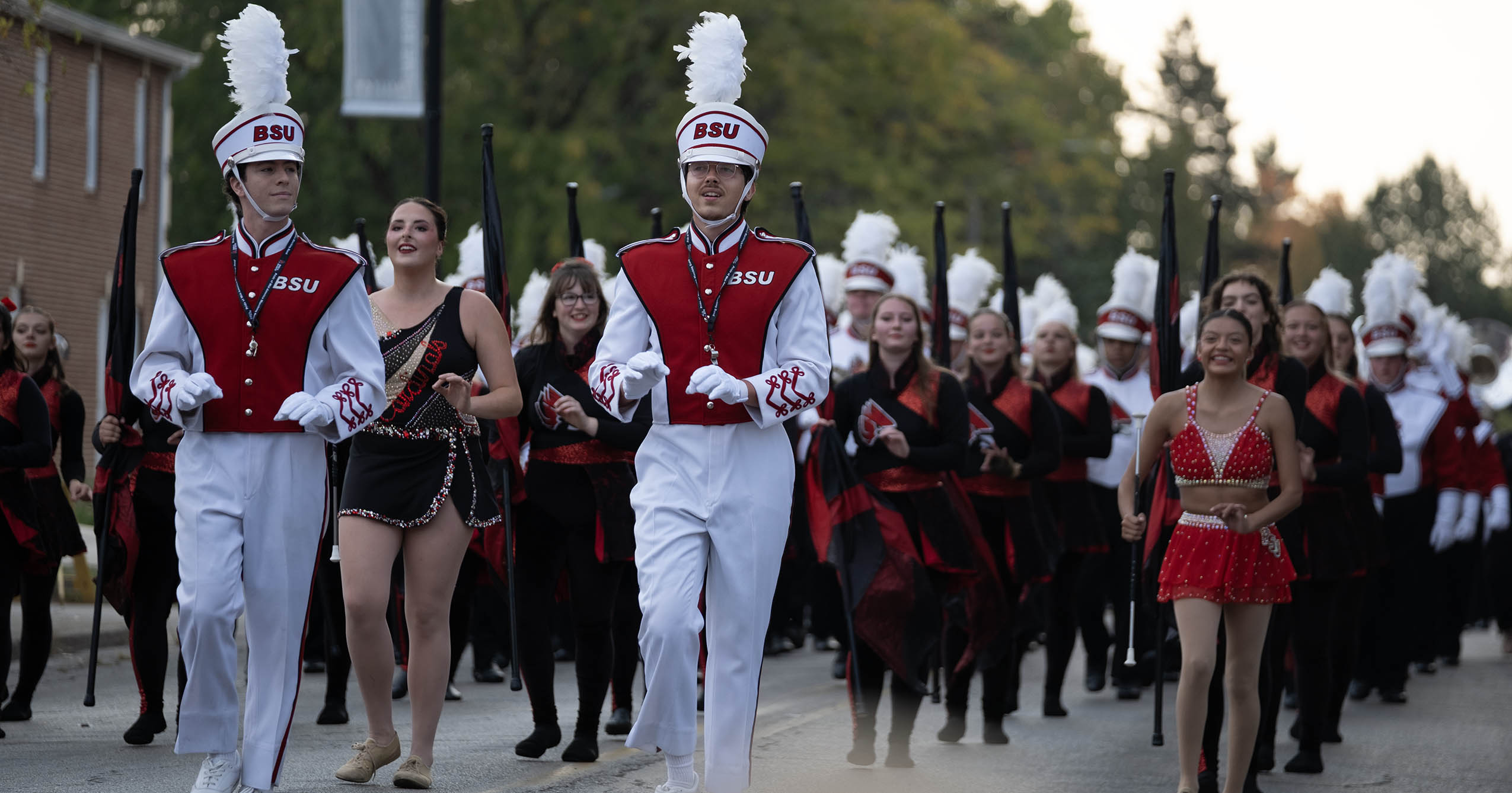Members of Ball State’s Pride of Mid-America Marching Band and color guard march in the 2025 Homecoming Parade.