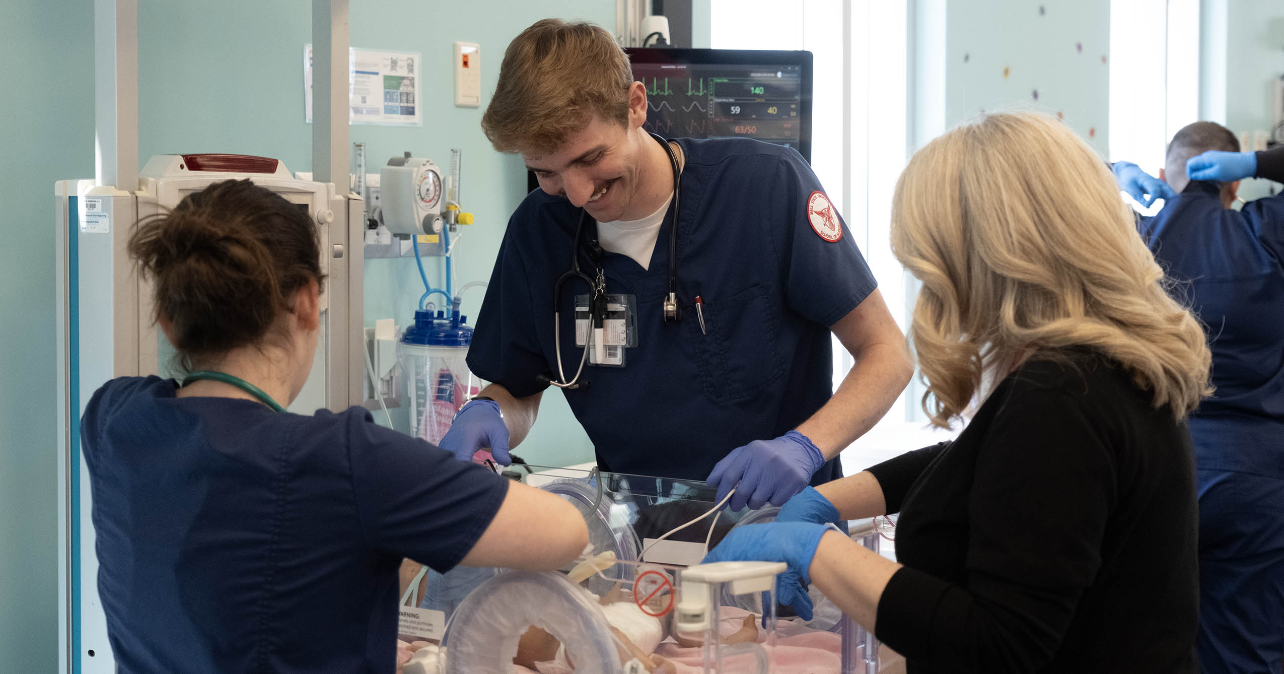 Ball State nursing students work with a patient simulator during a clinical simulation exercise.
