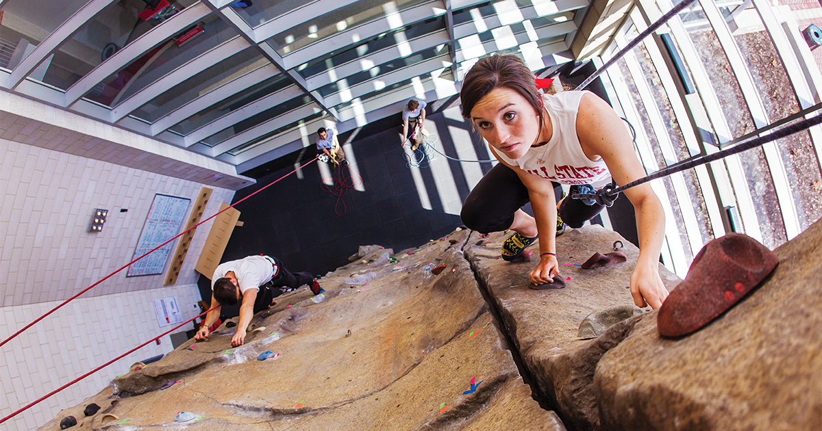 Woman climbing on wall