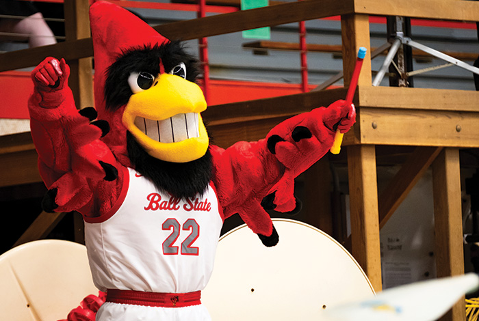 Charlie Cardinal rasing hands and cheering crowd on