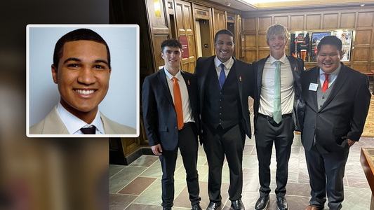 Cory Shaw’s professional headshot appears beside a group photo of four young men in suits standing together in a wood-paneled interior.