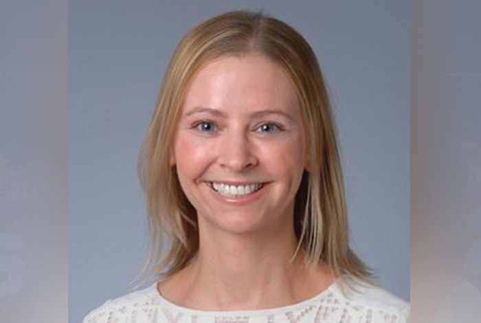 Headshot of Dr. Nicole Horn smiling against a gray background.